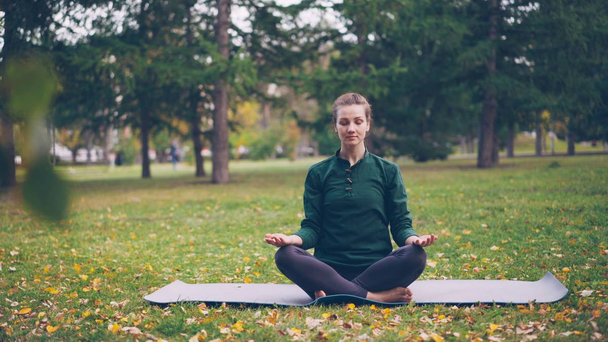 Woman practicing deep breathing at her desk as a stress management exercise for adults
